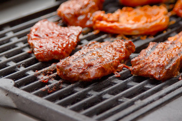 Grilling meat on gas grill at sunny day