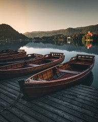 Naklejka na ściany i meble boats at lake bled slovenia during summer sunset