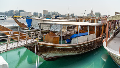 Fototapeta na wymiar Traditional wooden boats in the Corniche marina at Doha.