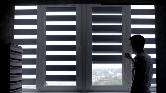 Man installing cassette roller blinds on windows