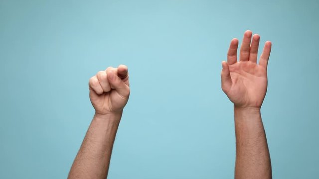 two arms pointing at camera with one hand then with both, gesturing a call me sign and waving fists on blue background