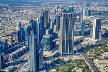 Naklejka na ściany i meble Dubai, United Arab Emirates - September 2, 2016. Urbanistic view of Dubai territories from the top of Burj Khalifa skyscraper, tall buildings on the sunny autumn day