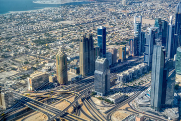 Dubai, United Arab Emirates - September 2, 2016. Urbanistic view of Dubai territories from the top of Burj Khalifa skyscraper, tall buildings on the sunny autumn day