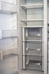 Fototapeta premium Open empty white refrigerator. Side View of Stainless Steel Double Door Refrigerator. Modern Kitchen and Domestic Household Appliances. 