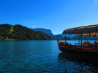 Naklejka na ściany i meble A boat floating on a calm blue lake.