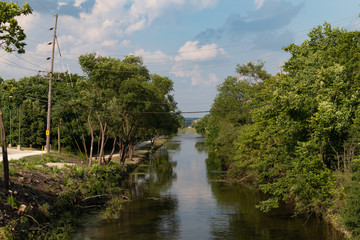 Canal in Downtown Lemont Illinois with Green Trees during Summer