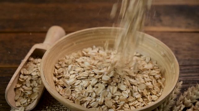 Oat flakes falling in a bowl in slow motion. Healthy food concept