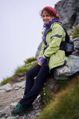 Woman hiking on a trail in the mountains