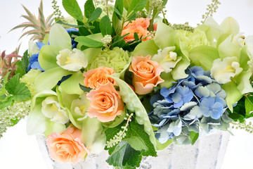 Flower arrangement on white background : cymbidium, carnation, anthurium, rose, hydrangea, clethra alnifolia, currant leaves, ornamental ananas