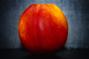 red peach on black background close up
