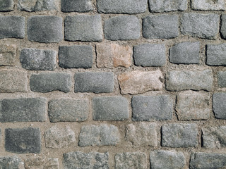 Texture of dark gray granite paving stones, top view. Background from natural block stone.