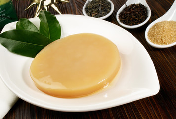 Kombucha Mushroom and Kombucha Ingredients on wooden Background