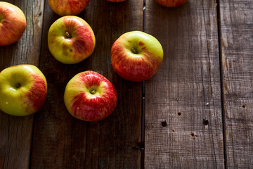 Composition of village red apples on a wooden table