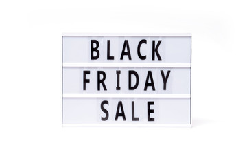 Black friday sale. Text on a vintage lightbox display placed on a white table on a light background. 