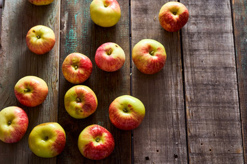 Composition of village red apples on a wooden table