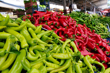 Selling green and red peppers on the market