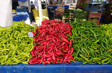 Selling green and red peppers on the market