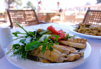 fried fish with vegetables in a restaurant