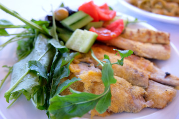 fried fish with vegetables in a restaurant