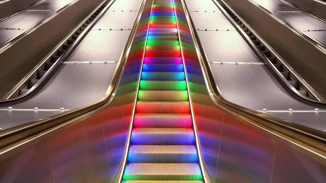 Modern Colorful infinity moving escalator at underground subway. Cinemagraph. Still image with moving stairs.
