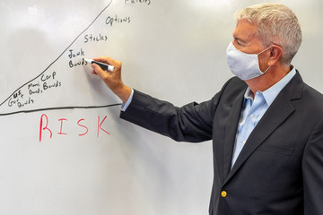 University professor in classroom wearing a mask for protection from the Covid 19 virus