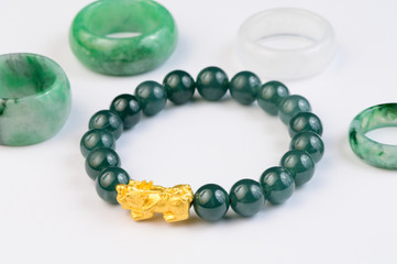 Green bracelet jade with jadeite ring on background