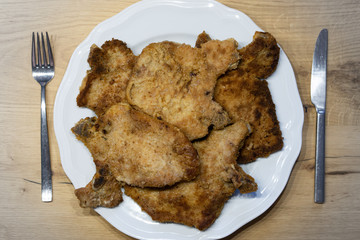 breaded chops or cutlets on a white plate