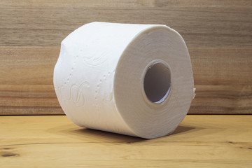 white toilet paper roll with wooden background