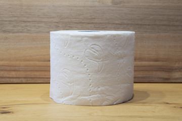 white toilet paper roll with wooden background