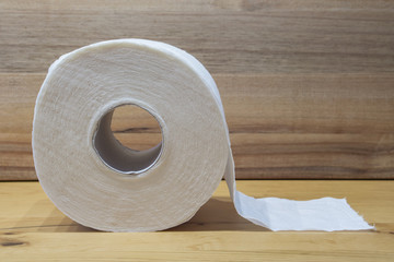 white toilet paper roll with wooden background