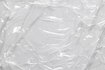 Cellophane plastic wrinkle clear surface with creases for macro light gray abstract wallpaper and background