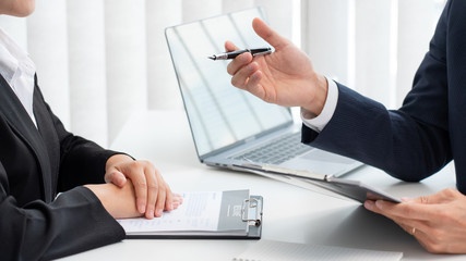 confident businessman sitting in front of office manager talk conducting to interviewer with colleague or boss for business