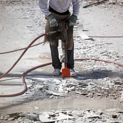 Jackhammer breaking up swimming pool for resurfacing
