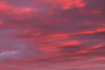 Romantic pink red sky with thick clouds at sunset