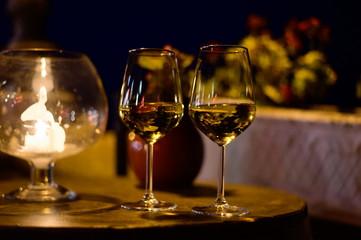 Two glasses of cold dry white wine served outdoor in cafe at night in Italy