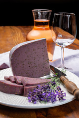 Cheese collection, pieces of violet hard cheese made with aromatic lavender seeds and fresh lavender flowers