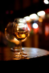 Two glasses of cold dry white wine served outdoor in cafe at night in Italy