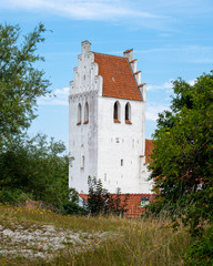 Fototapeta premium The steeple tower of Falsterbo church standing almost at the beach in the south west tip of Sweden
