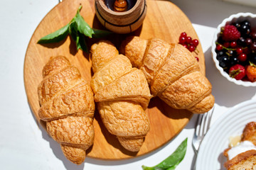 Traditional French croissant on white table background
