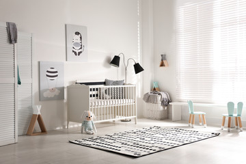 Cute baby room interior with crib and decor elements