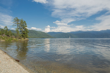 Lake Teletskoye with calm water on a summer day .Altai territory