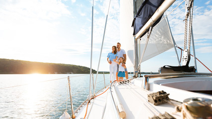 Family Relaxing On Yacht Enjoying Boat Ride Standing Outdoor, Panorama