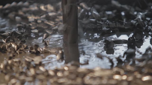 Industrial drill drilling an iron plate.