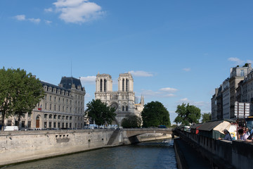 Fototapeta na wymiar Cathedral Notre-Dame de Paris, prefecture de police court and the Petit Pont Cardinal Lustiger viewed from the seine river cruise, Paris.