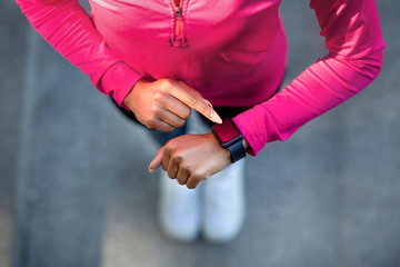 Closeup of smartwatch on sporty black girl hand