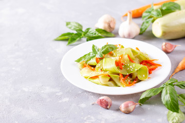 Fresh Tasty Vegetable Vegetarian or Vegan Grated Salad with Carrot, Zucchini, Sesame on Plate. Copy space.