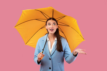 Portrait of beautiful young girl holding umbrella