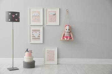 Fototapeta na wymiar Children's room interior with floor lamp and cute pictures on wall