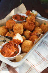 Cheese balls with tomato sauce. Fried snack starter meal. Party food