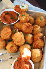 Cheese balls with tomato sauce. Fried snack starter meal. Party food